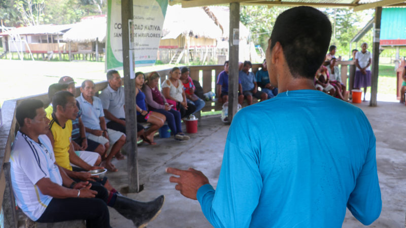 Community members in San Juan de Miraflores, Peru, discussing the success of Rainforest Alert