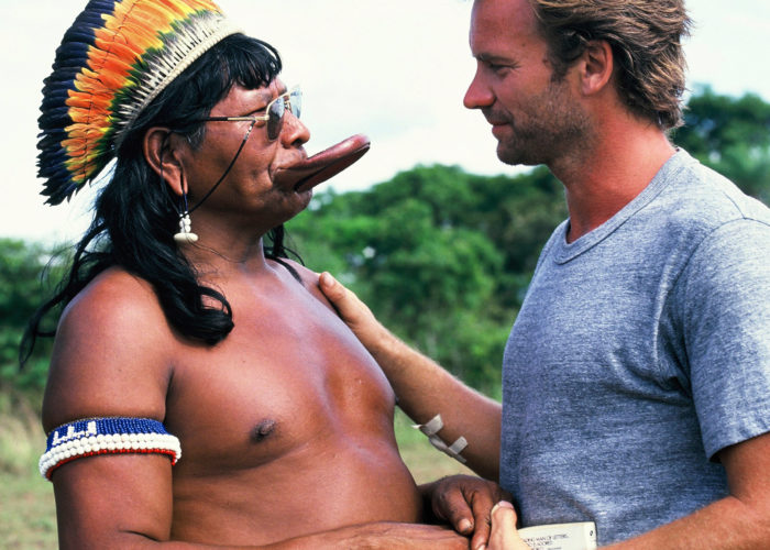 Historical image from the late 1980's of Sting shaking hands with Chief Raoni of the Kayapo people of Brazil