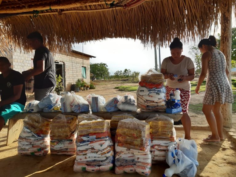 In response to COVID-19, four indigenous leaders prepare bags of food and medical supplies to distribute to communities