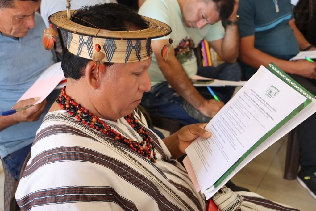 Indigenous Communities Lead Climate Adaptation Strategies in the Peruvian Amazon 1 An Ashaninka leader reviews AIDESEP's climate adaptation strategy