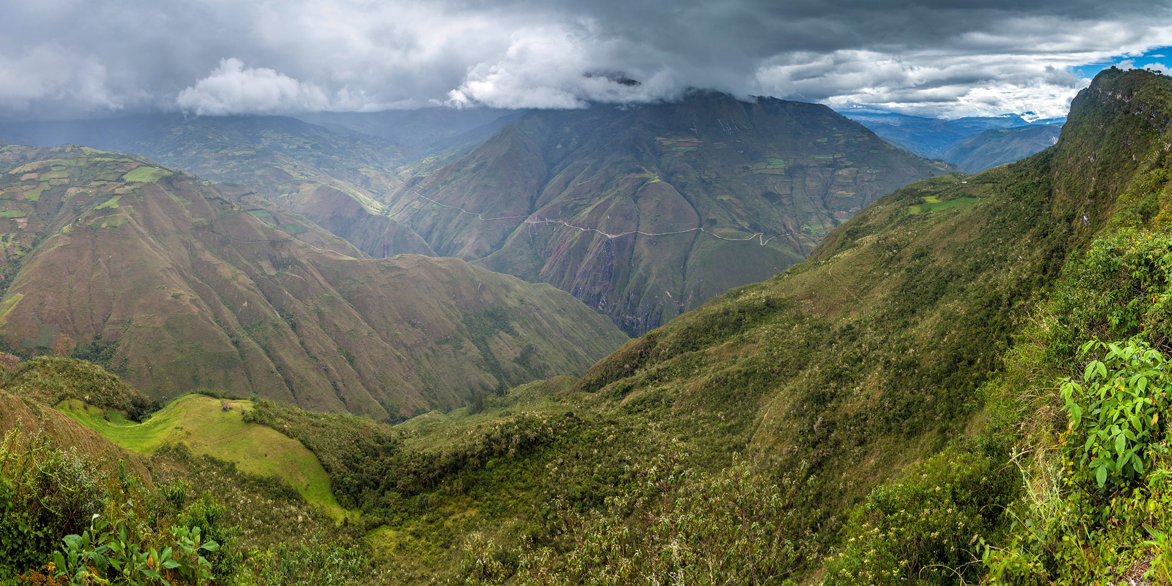 Panorama of verdant mountains and clouds near the Kuelap ruins in Peru