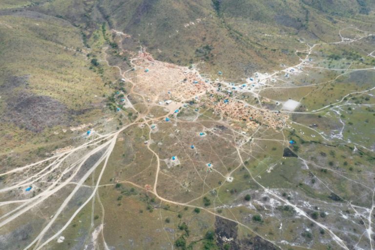 Aerial view of a large gold mining operation in the middle of an indigenous territory.