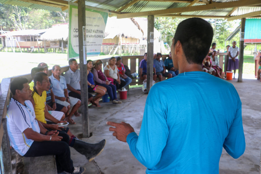 Community members in San Juan de Miraflores, Peru, discussing the success of Rainforest Alert