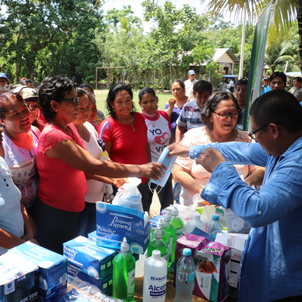 Jorge distributing medical supplies to a group