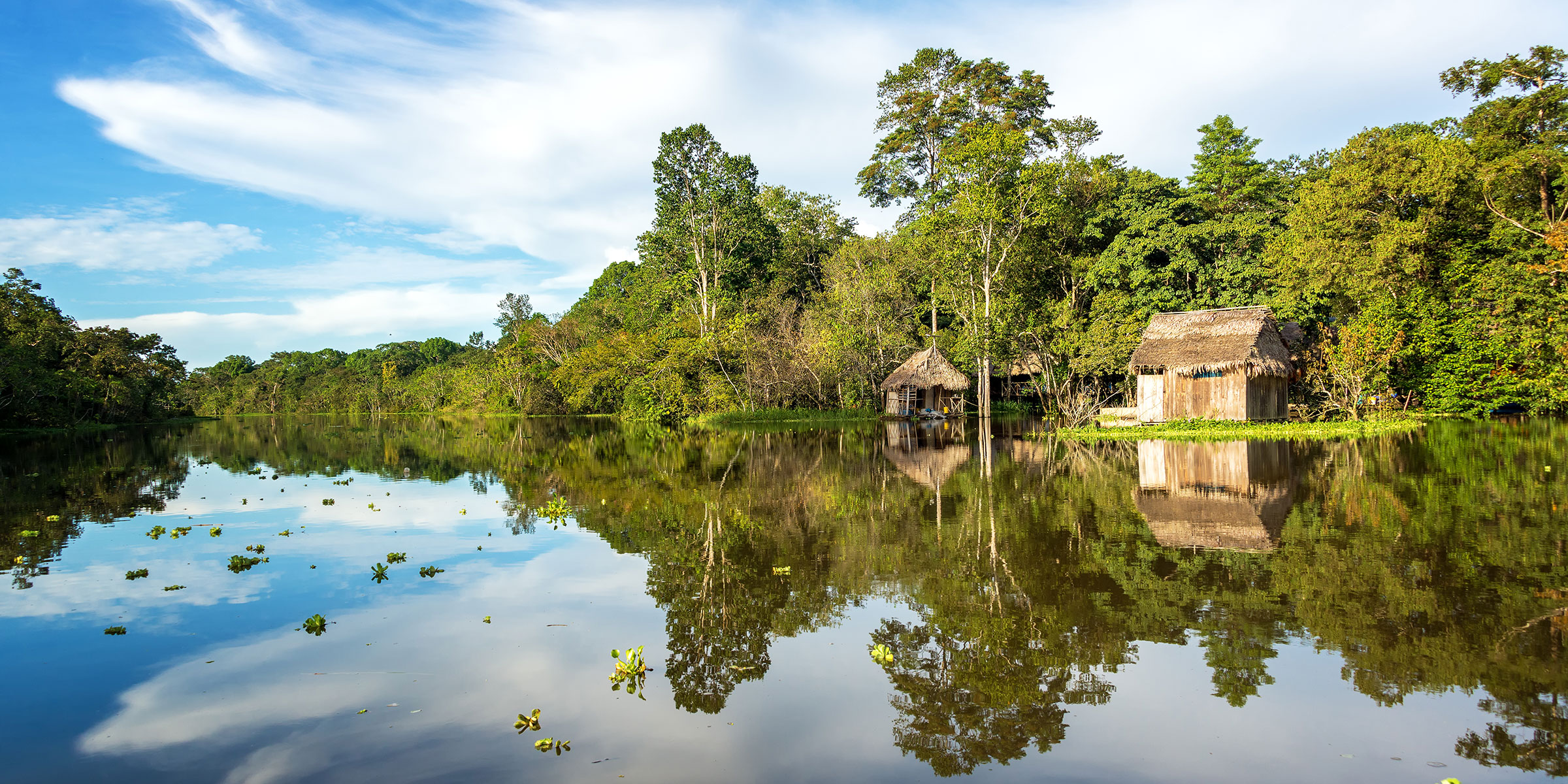 Small wooden homes on the banks of the Yanayacu River near Iquitos, Peru
