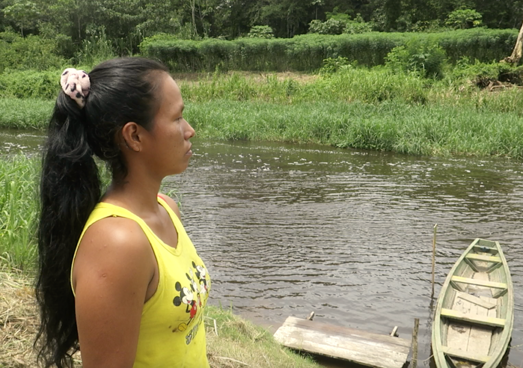 Jhuliana stares thoughtfully to her community's river