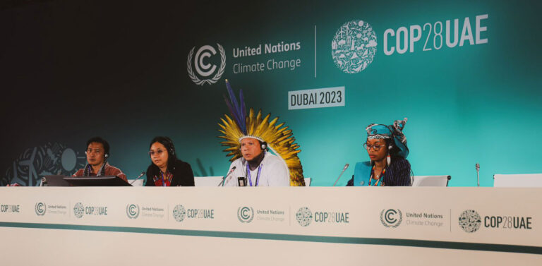 Indigenous representatives speaking at COP28 podium