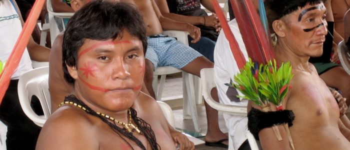 Indigenous community members convene for a village meeting