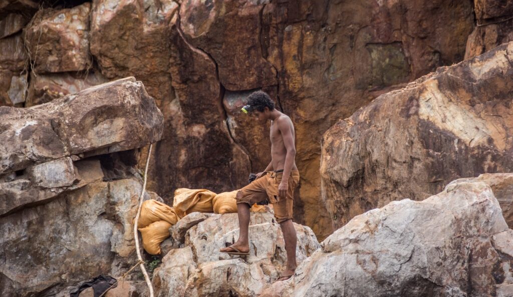 a man standing on rocks of the mine